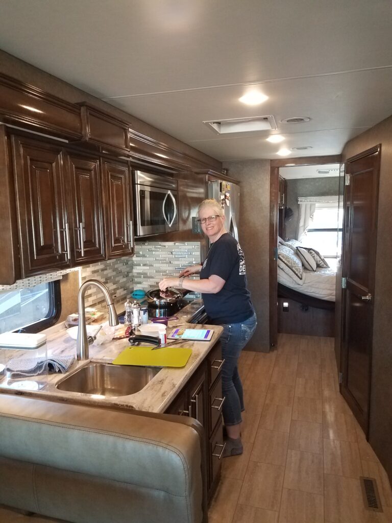 Lisa making dinner in our RV.