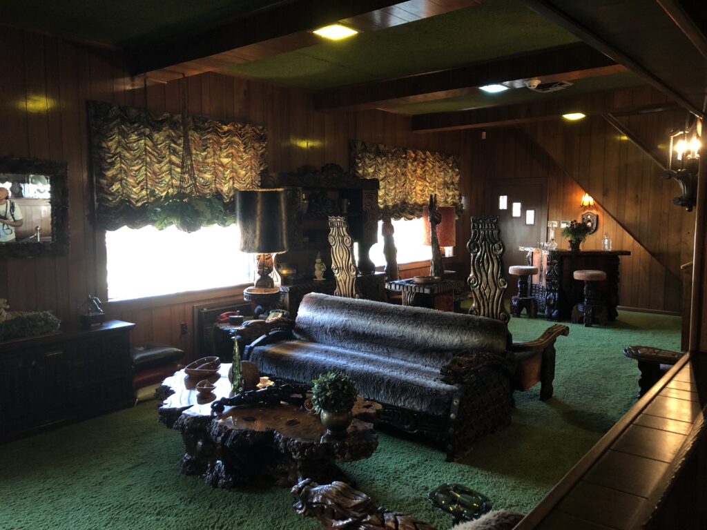 The Jungle Room inside Graceland with green shag carpet and exotic wood furniture