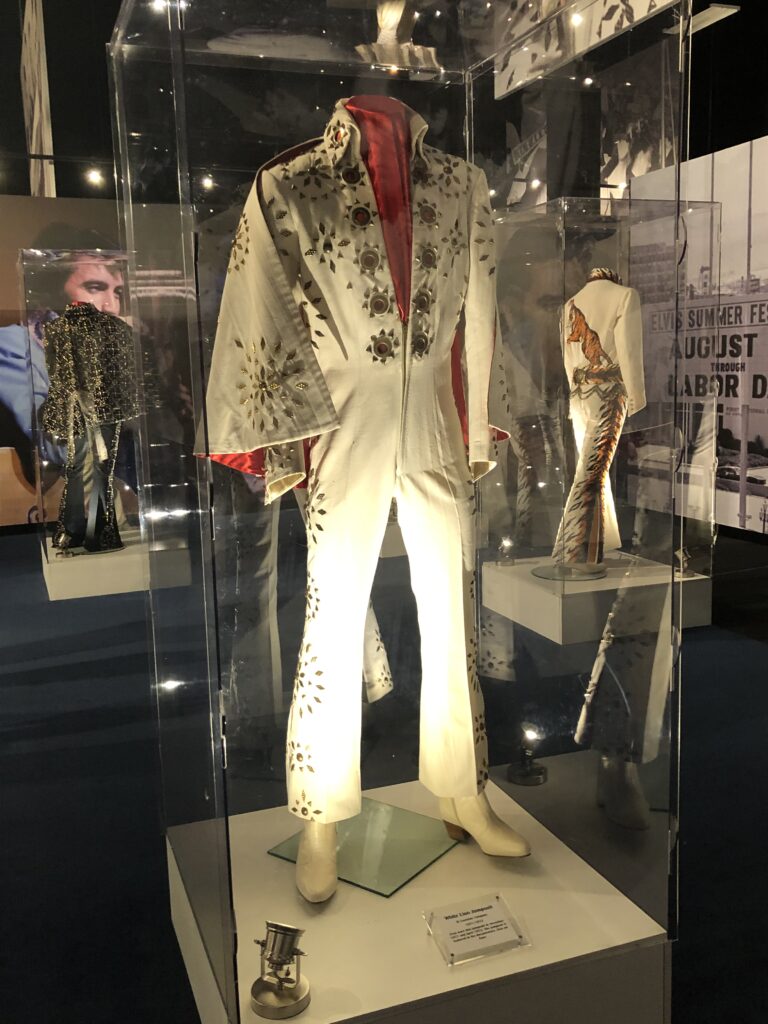 Display case of Elvis Presley stage costumes and gold records at Graceland
