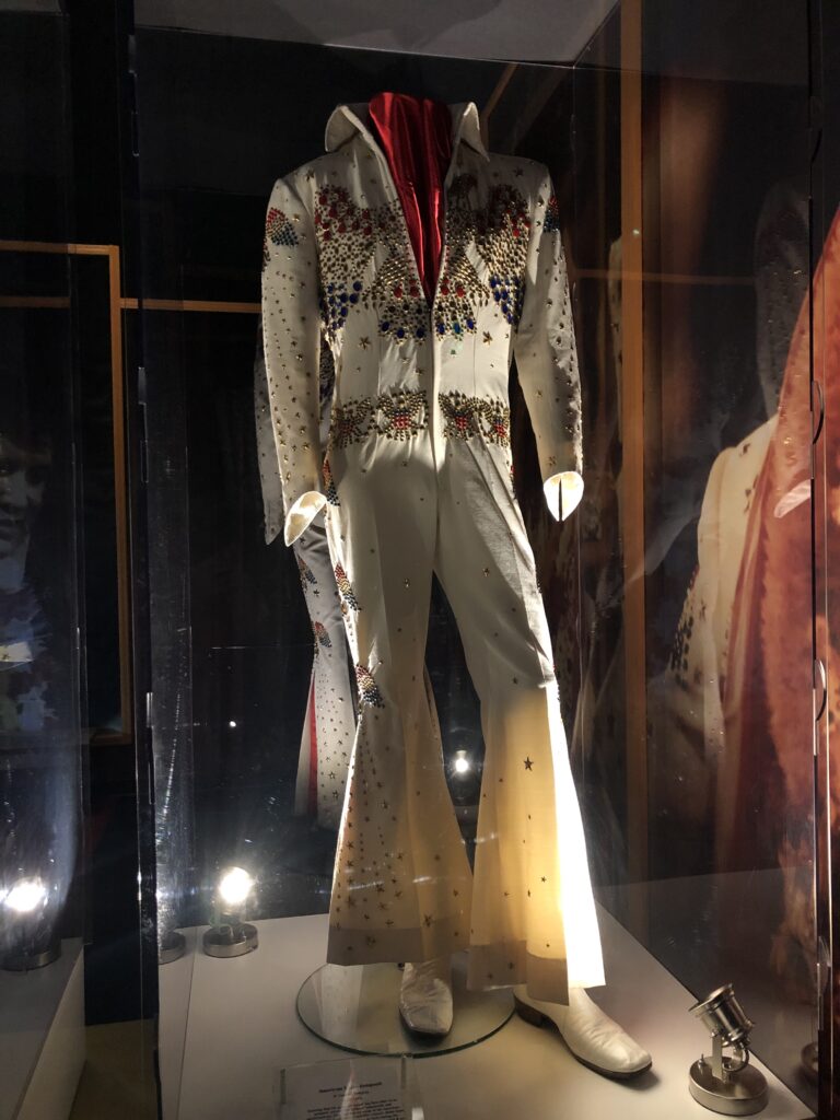 Display case of Elvis Presley stage costumes and gold records at Graceland