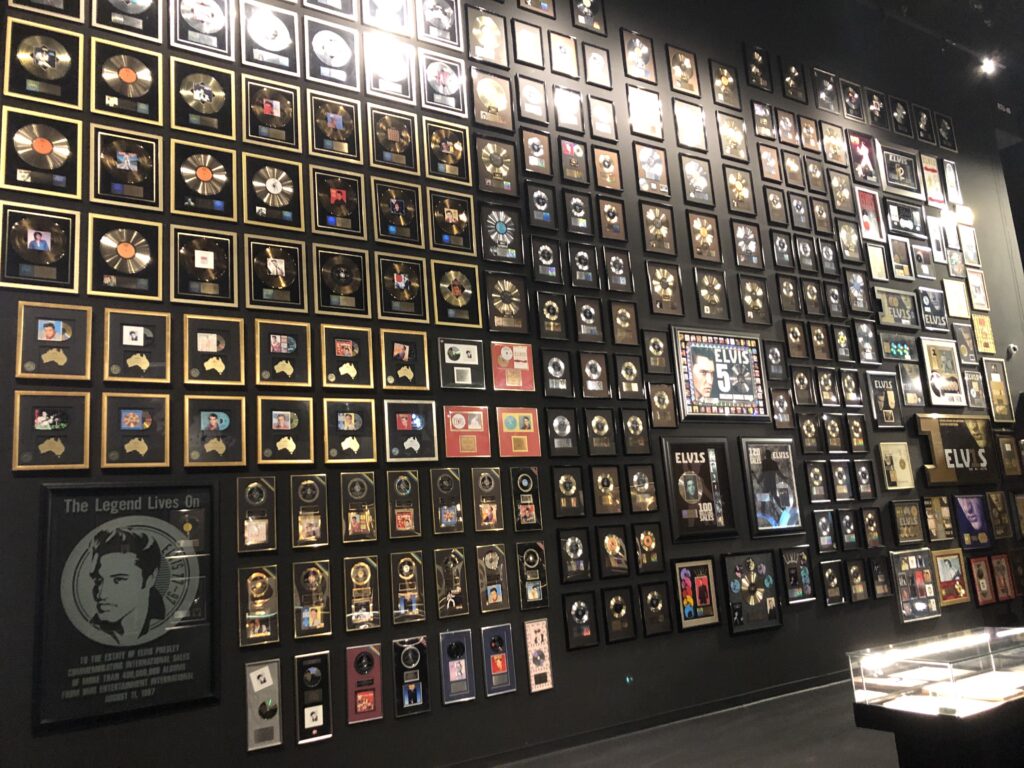 Display case of Elvis Presley stage costumes and gold records at Graceland