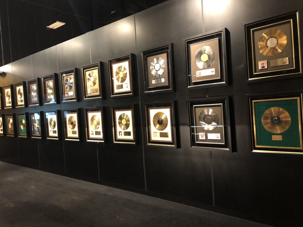 Display case of Elvis Presley stage costumes and gold records at Graceland