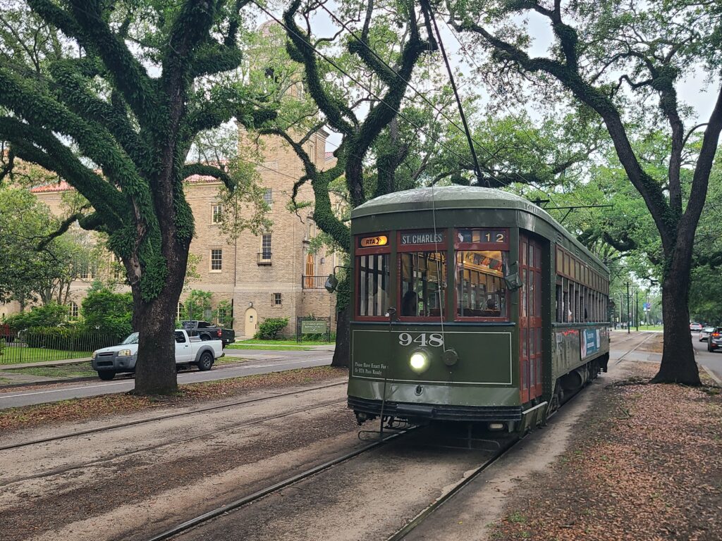 Historic St. Charles streetcar beneath the live oaks near Walnut Street