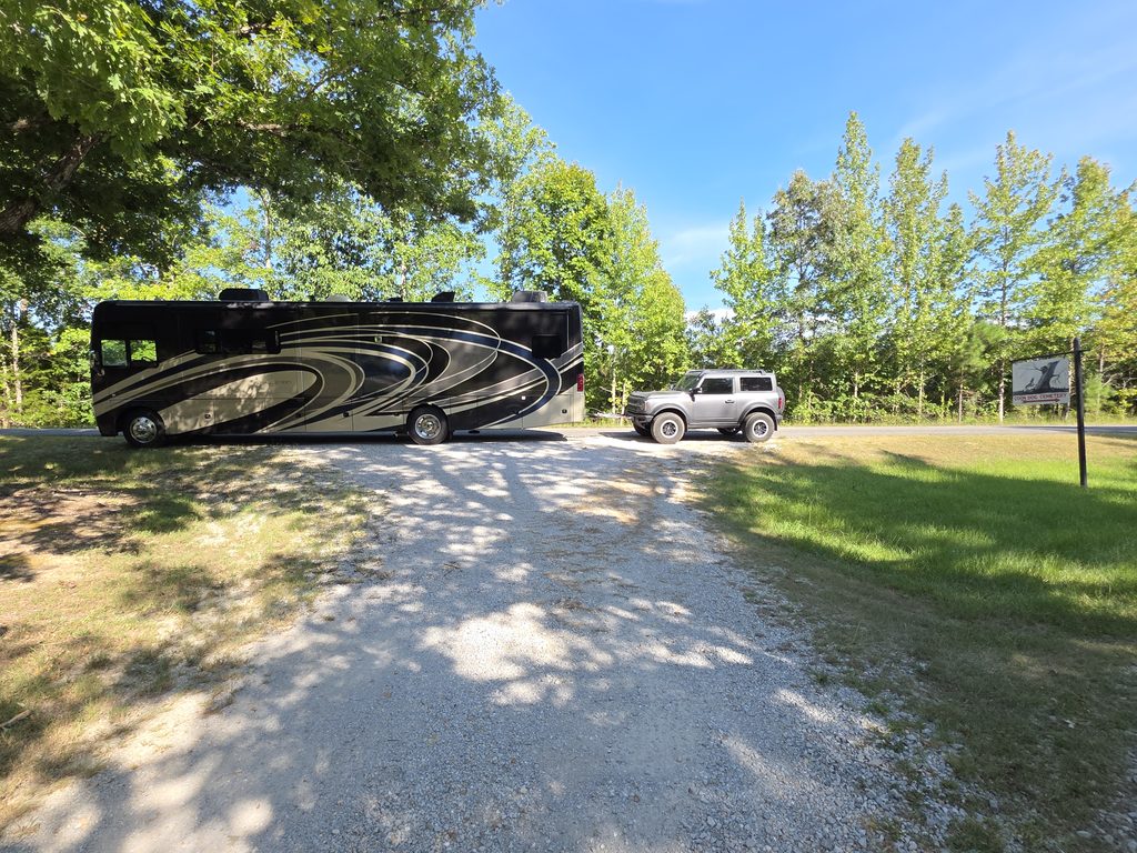 Our motorhome and toad in front of the Coon Dog Cemetery Sign.