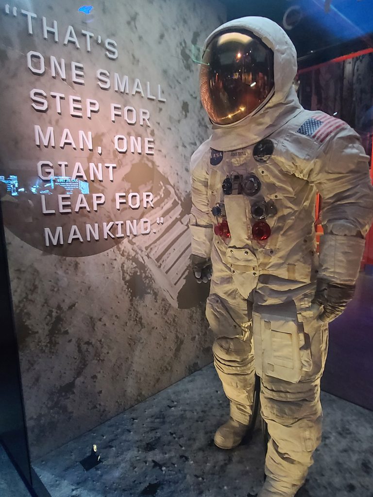 Neil Armstrong's Apollo 11 spacesuit displayed alongside words that became part of history.